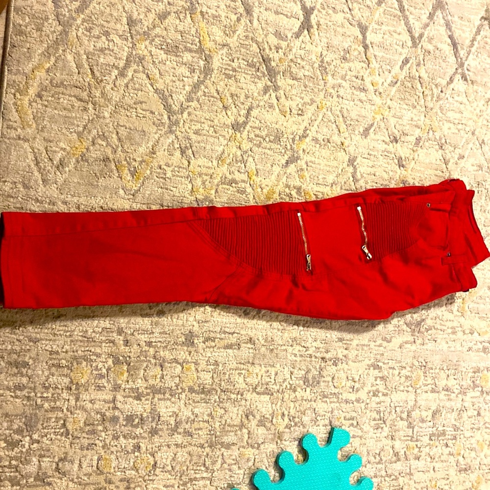 Red jeans with zippers.